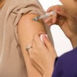 A closeup image of an arm receiving a vaccine injection.